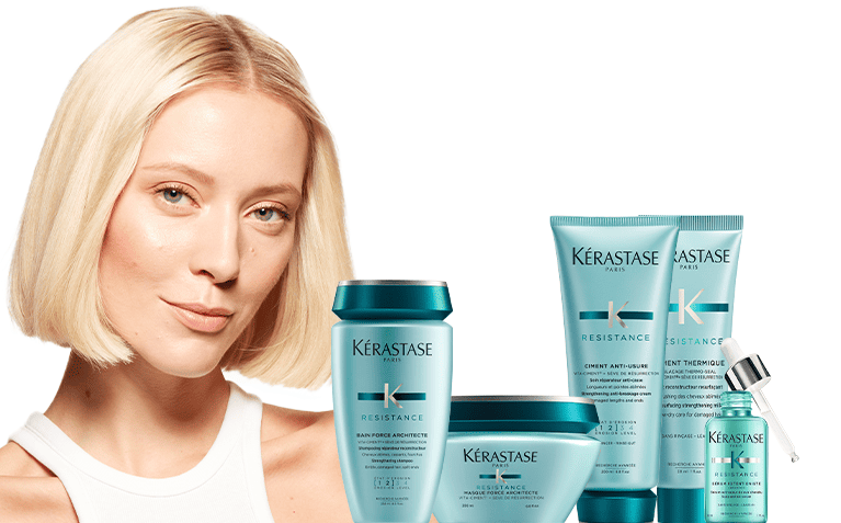 Kerastase Resistance model with hair care products for damaged hair